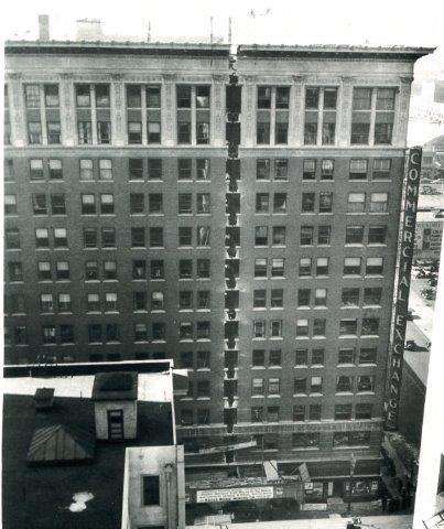 Historic photo showing seam between paired windows to recess the front half off the building to create a wider sidewalk.